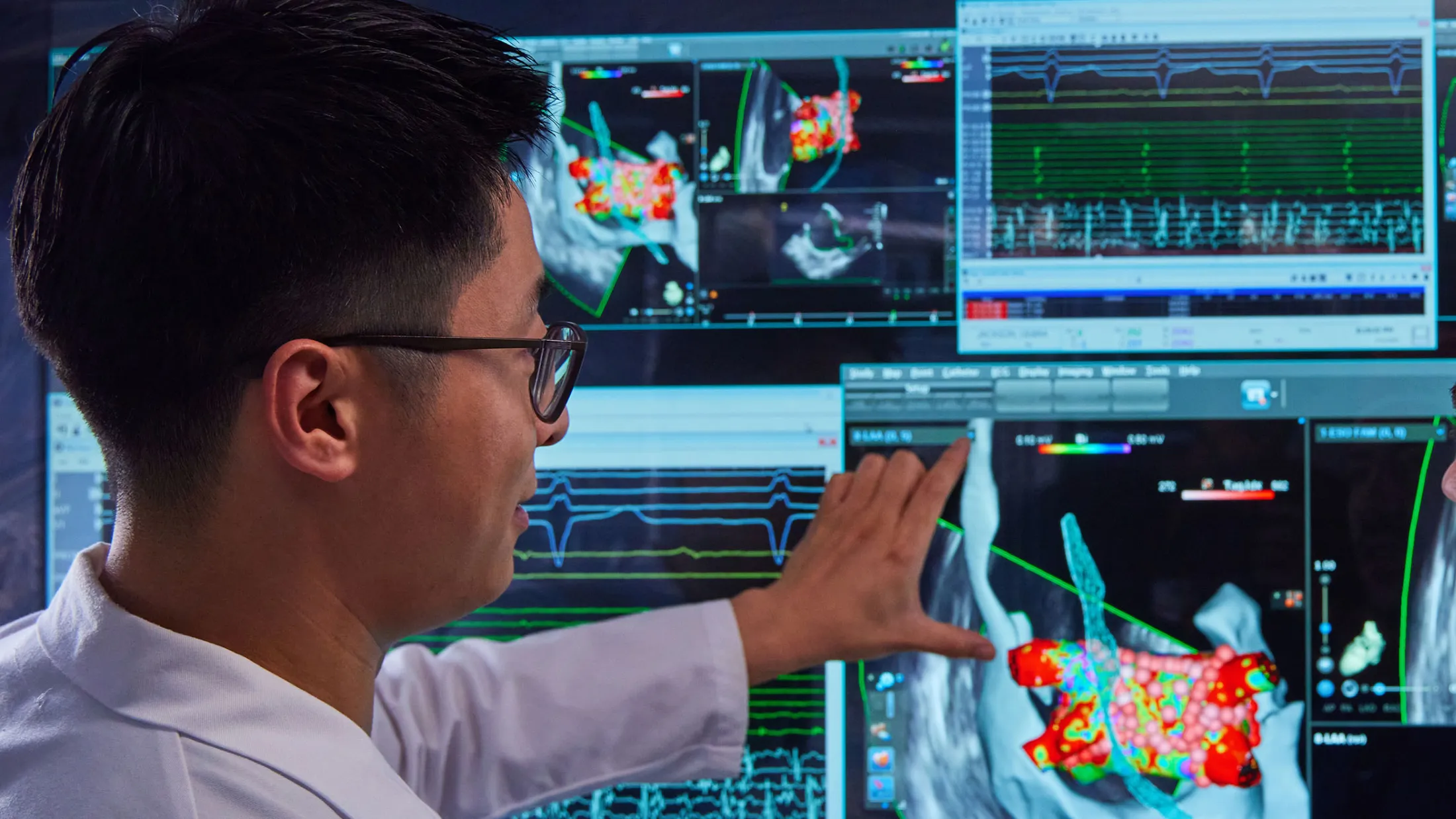 Two physicians in a lab looking at computer screens