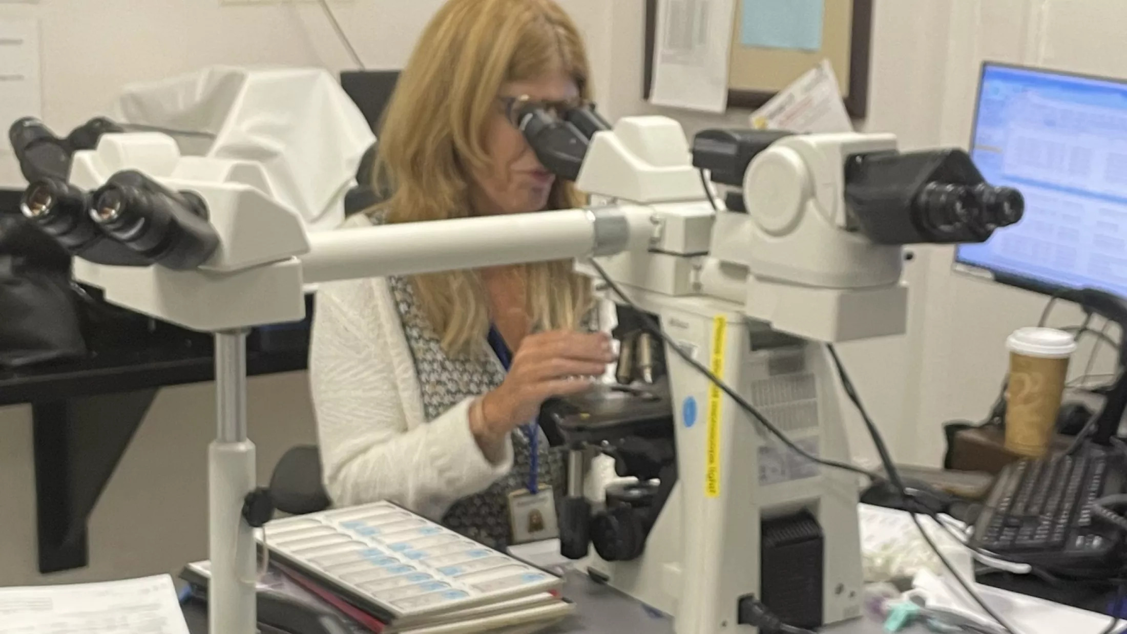 Dr. Susan Fineberg analyzing breast specimens at her microscope