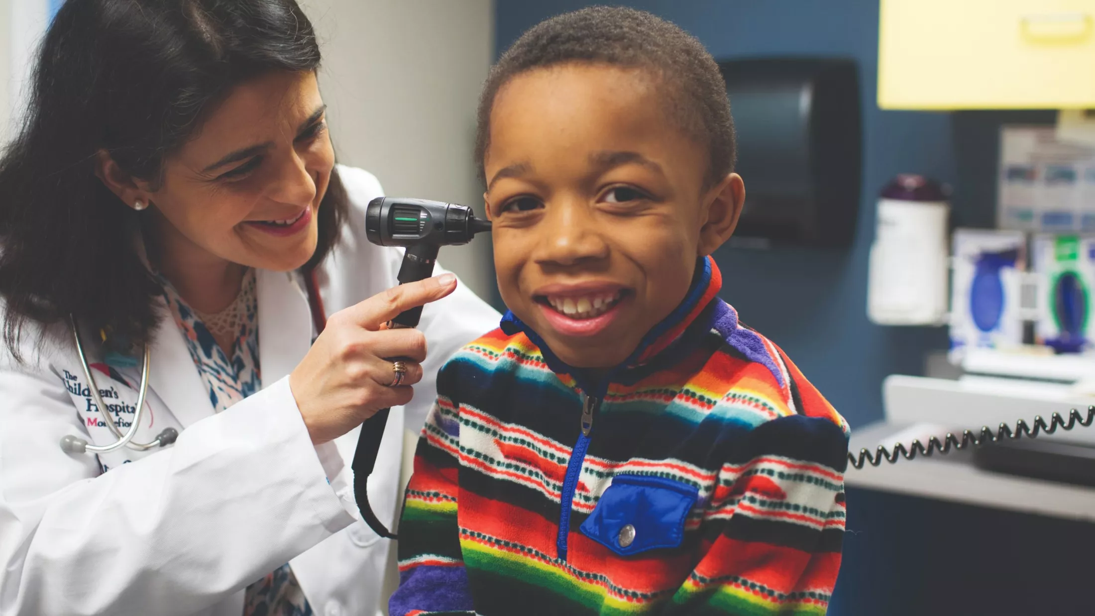 Smiling child being examined by a Children's Hospital at Montefiore Einstein provider