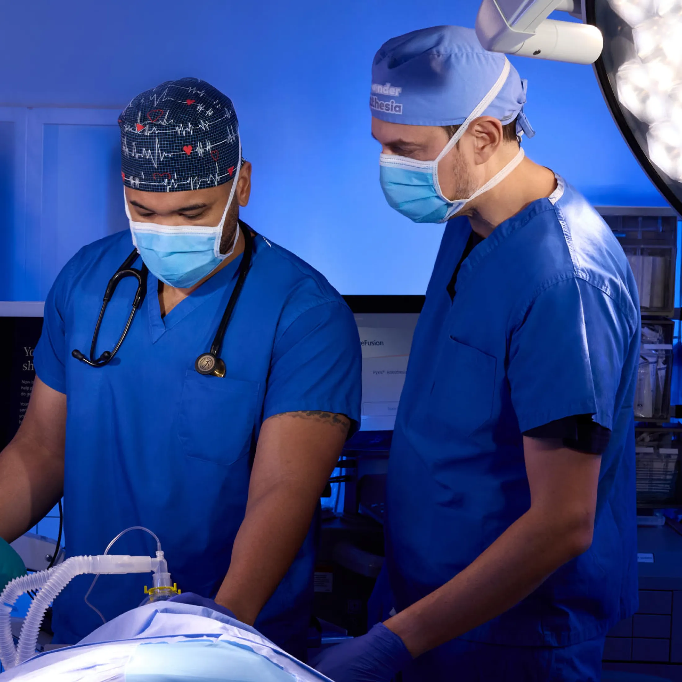 Two anesthesiologists attending to a patient in a theatre