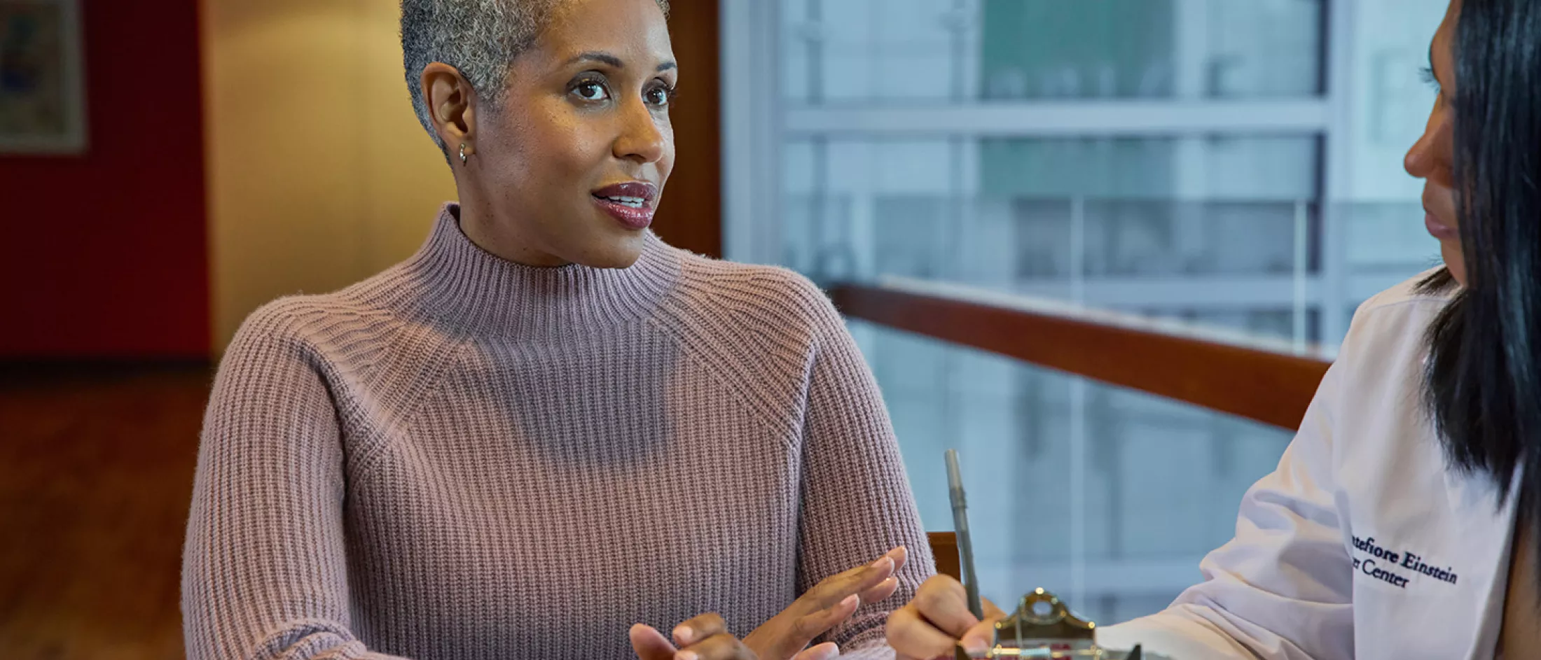 Woman talking to doctor.