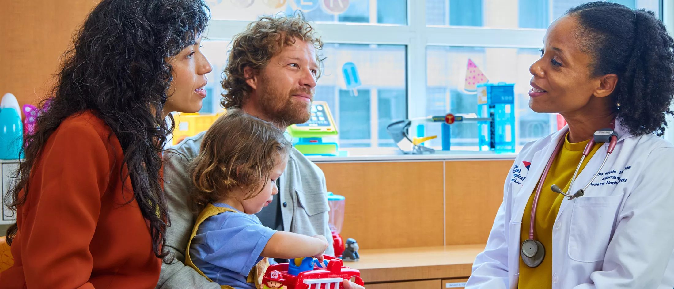 A family visiting a pediatric nephrologist.