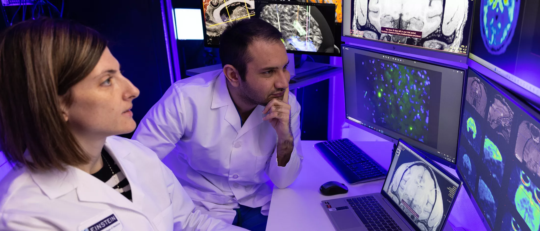 Two physicians looking at a computer monitor in a lab