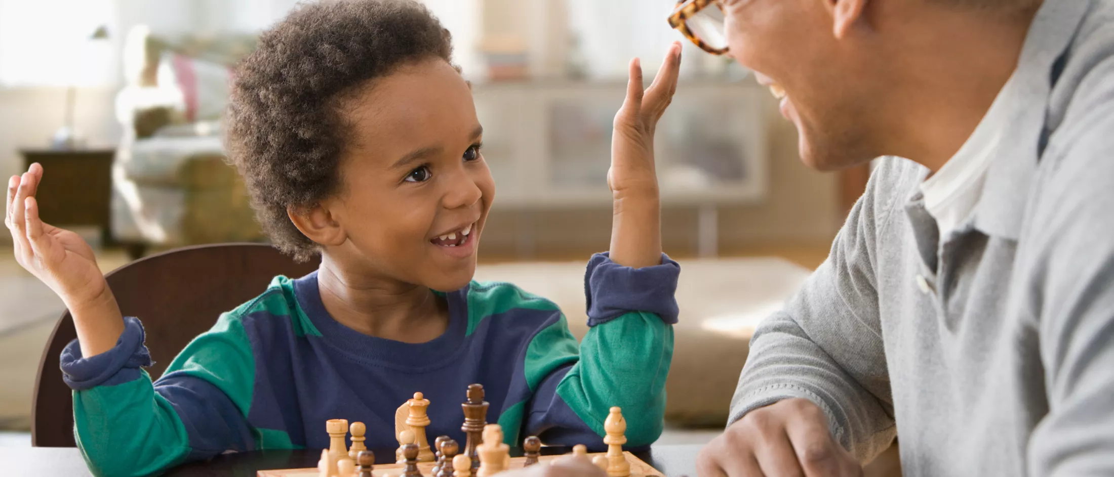 Grandfather and grandson playing chess together