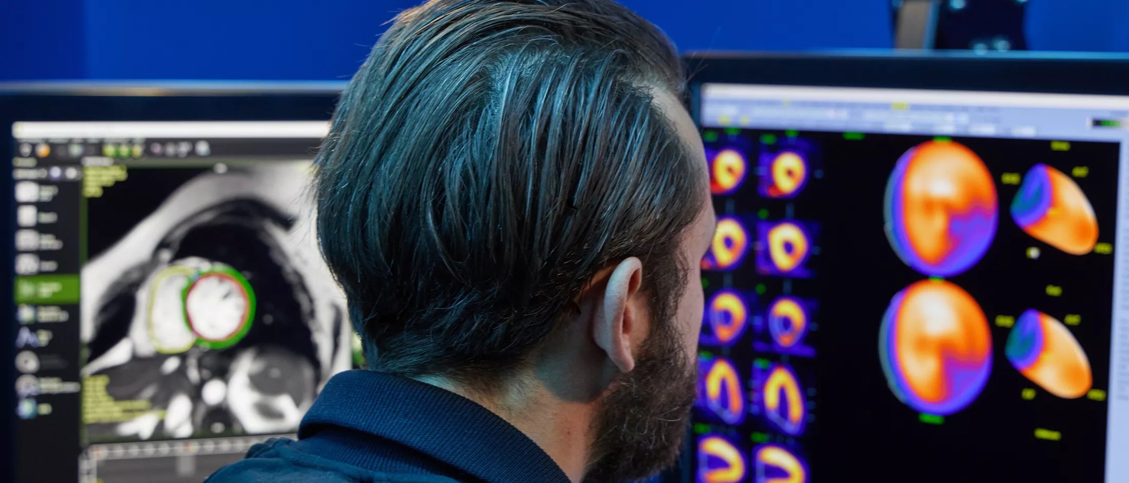 A physician looking at a computer screen