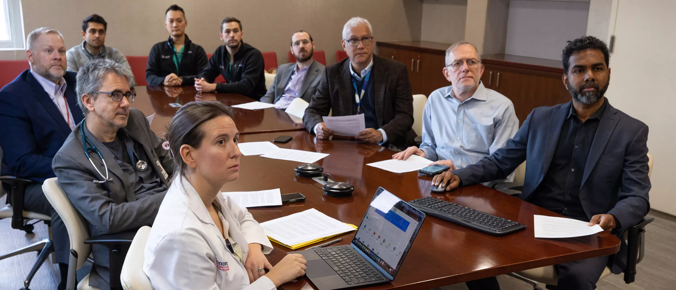 A group of doctors sitting in a conference room 
