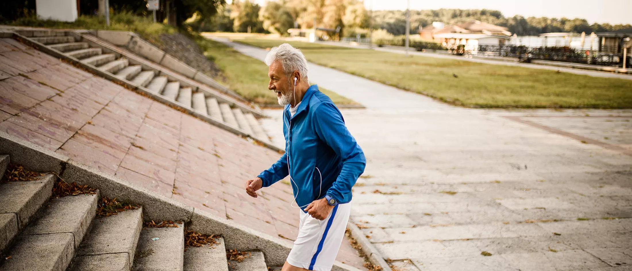 Side view of a senior man running up the stairs