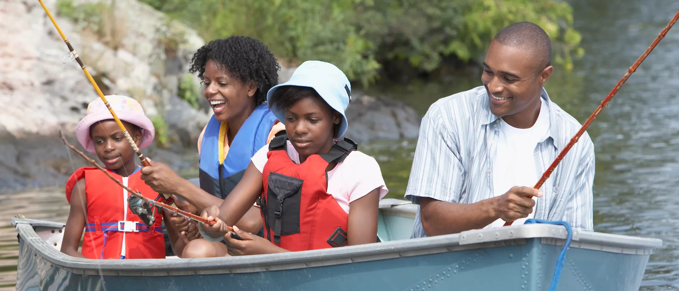 A family enjoying fishing while on a small boat