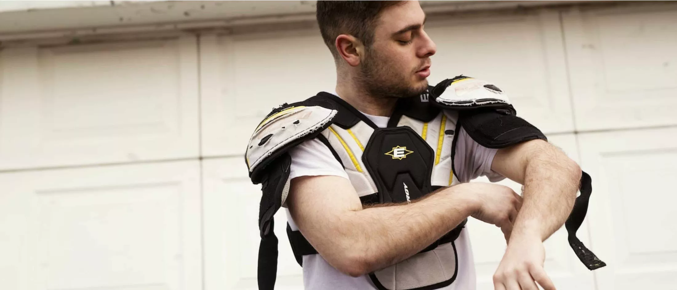 Jake putting on shoulder pads