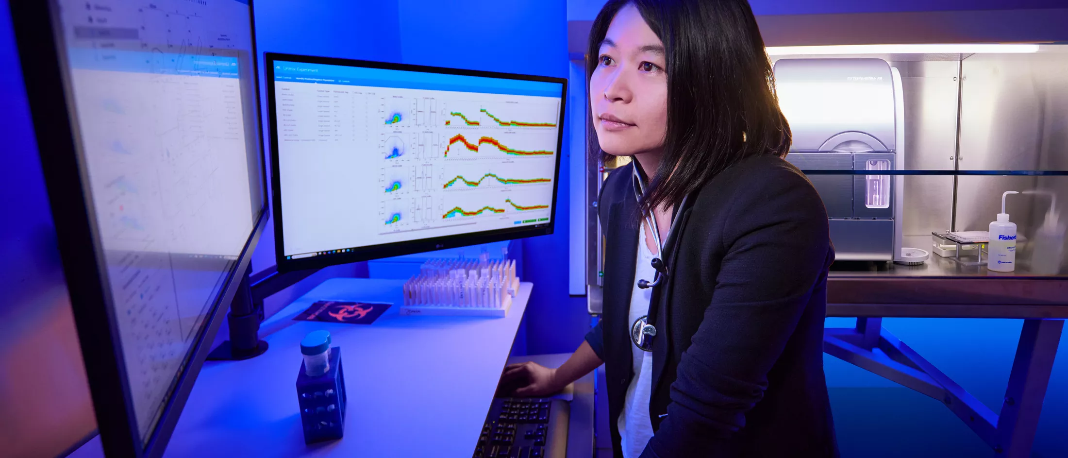 A researcher sitting in front of computer monitors