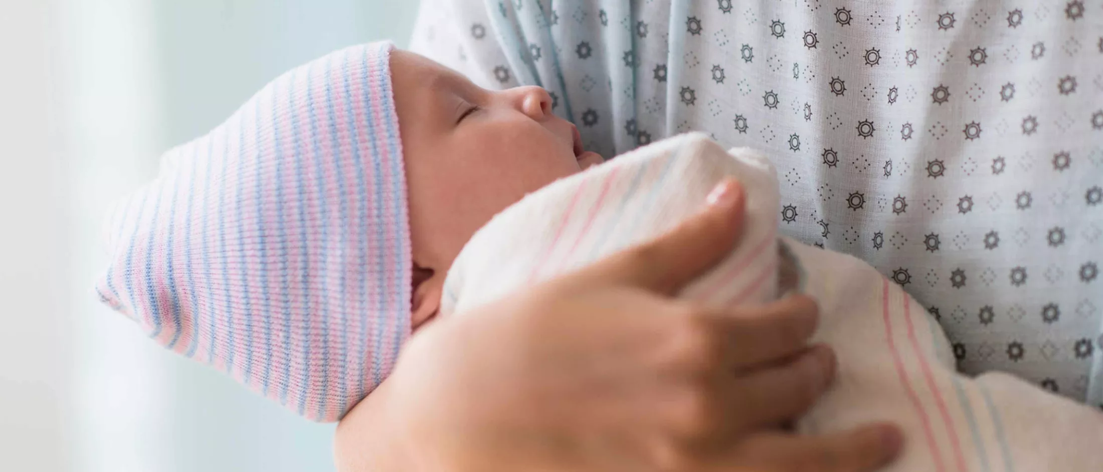 Mother holding her newly born sleeping baby