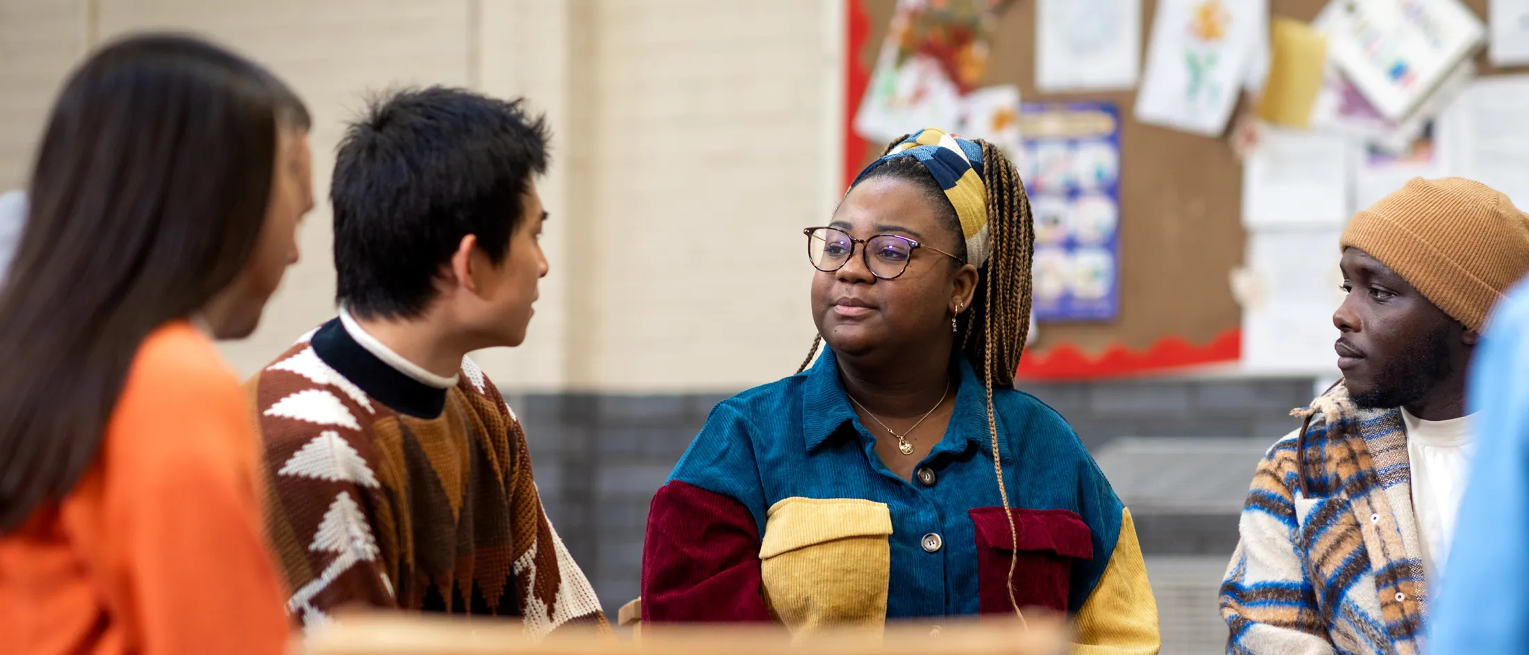 Group of young adults sitting in a circle having a discussion