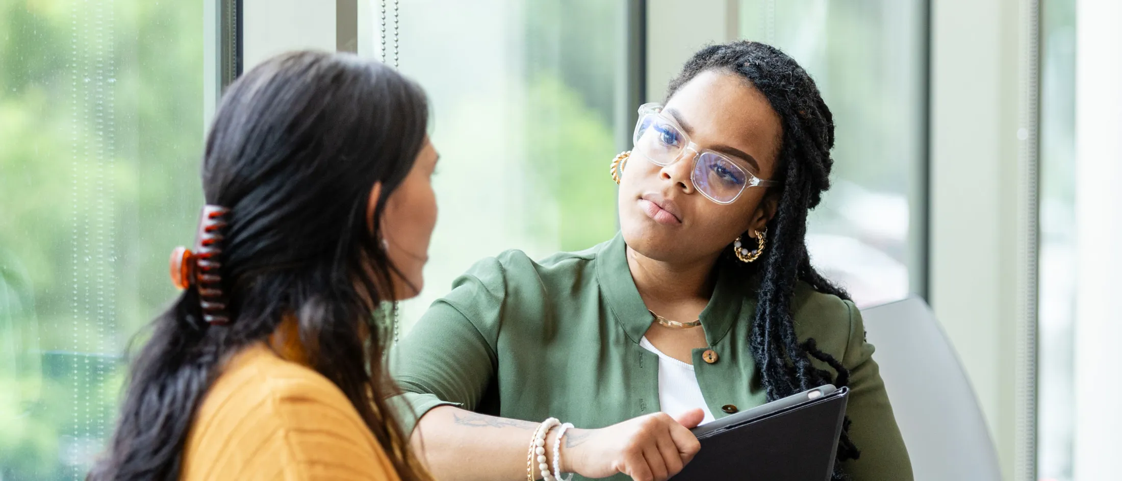 Therapist attentively listening to a woman during a counseling sessi