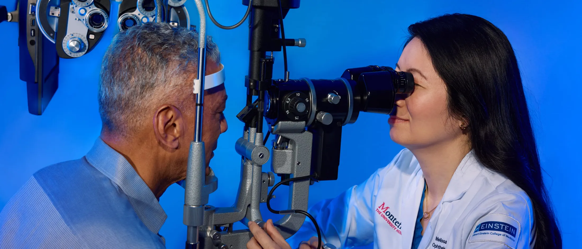 Ophthalmologist sitting with a patient and examining his eyes
