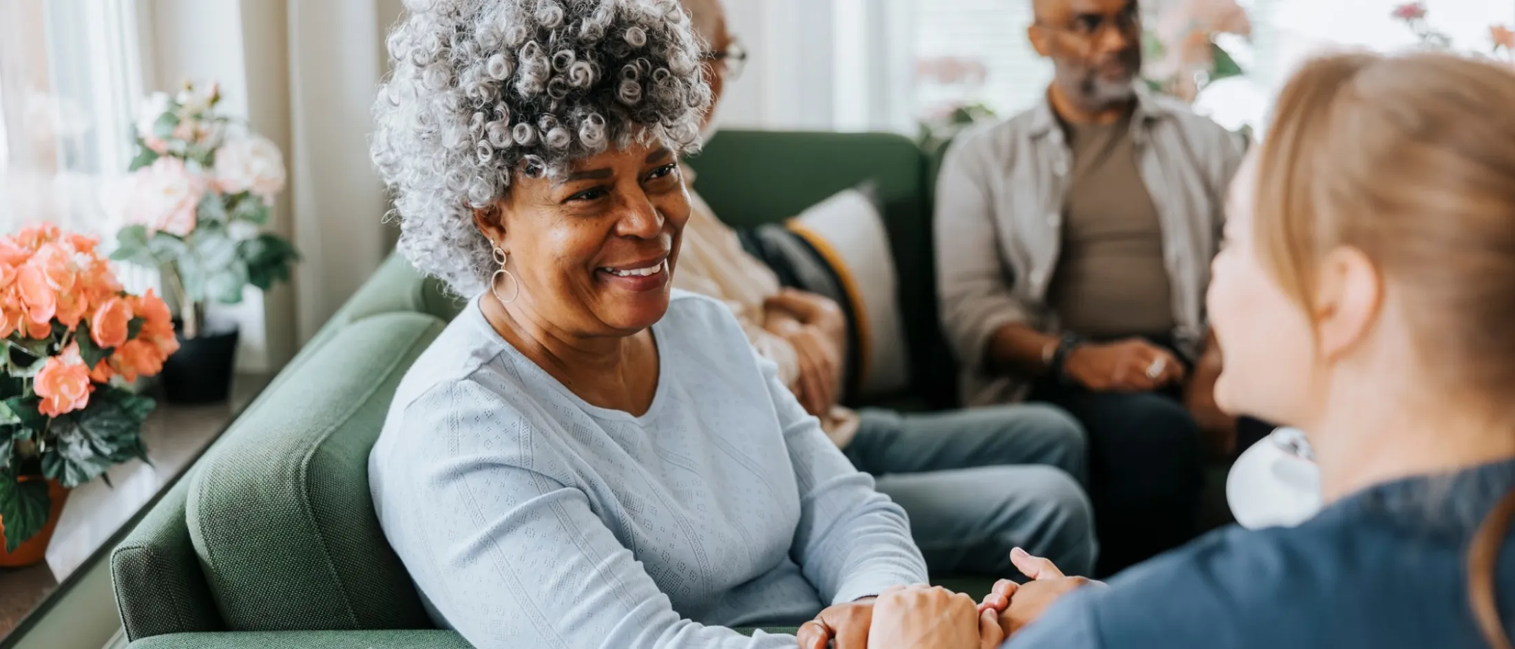 Old woman smiling and conversing with nurse