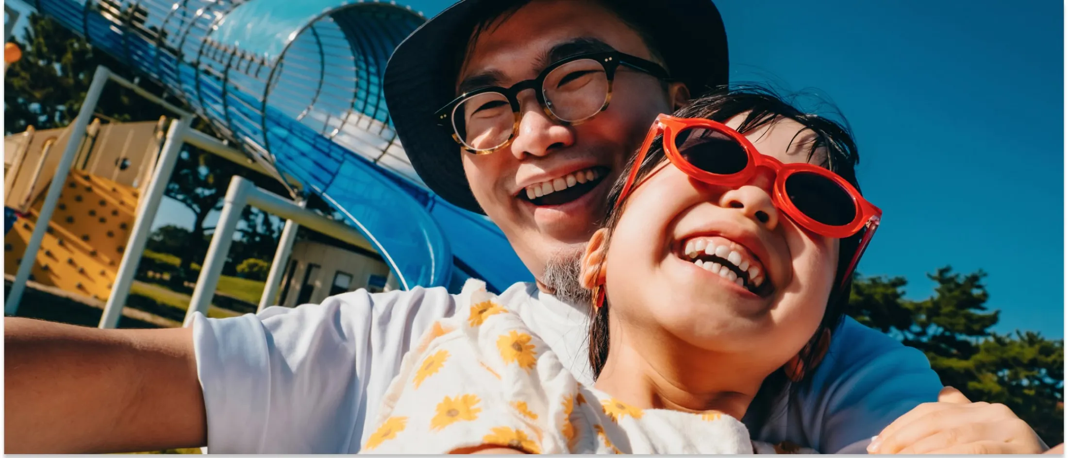 Adult and a child sharing a happy moment at a park