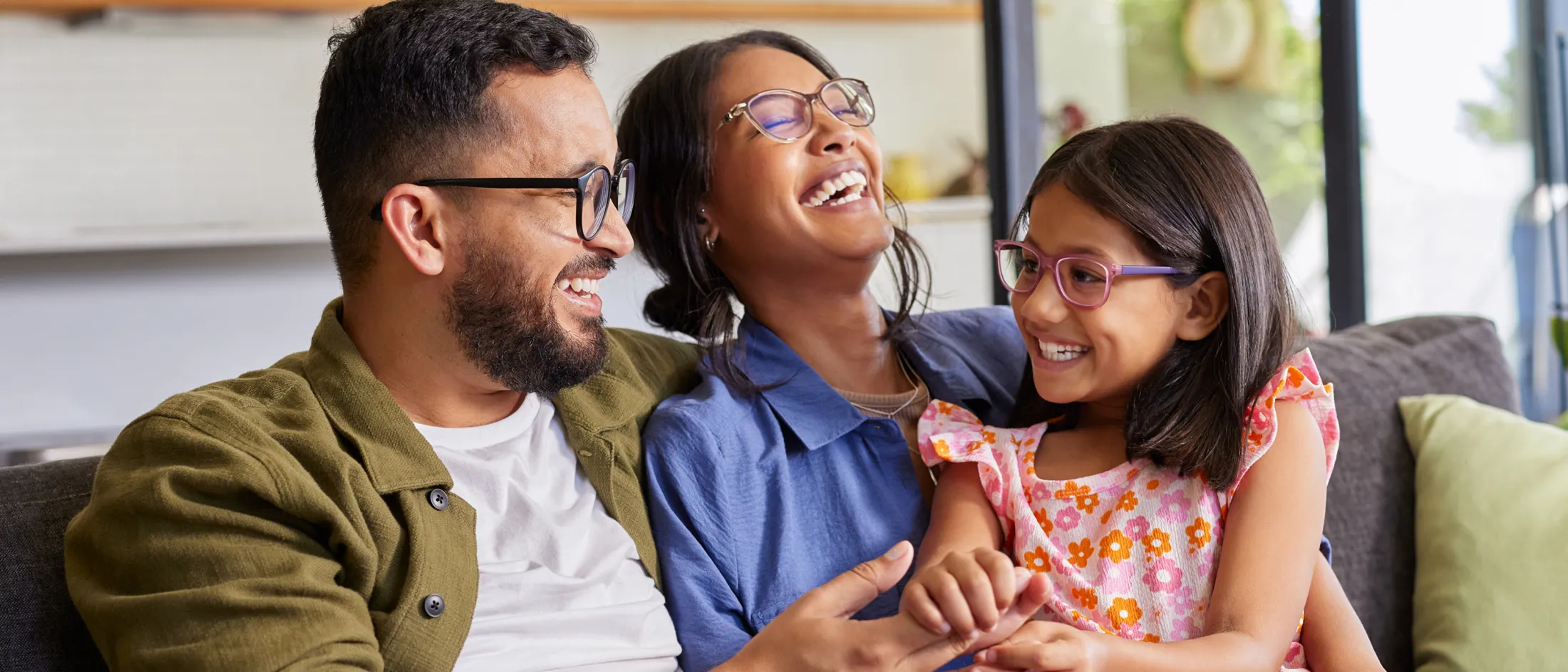 Family wearing glasses and sitting on a couch