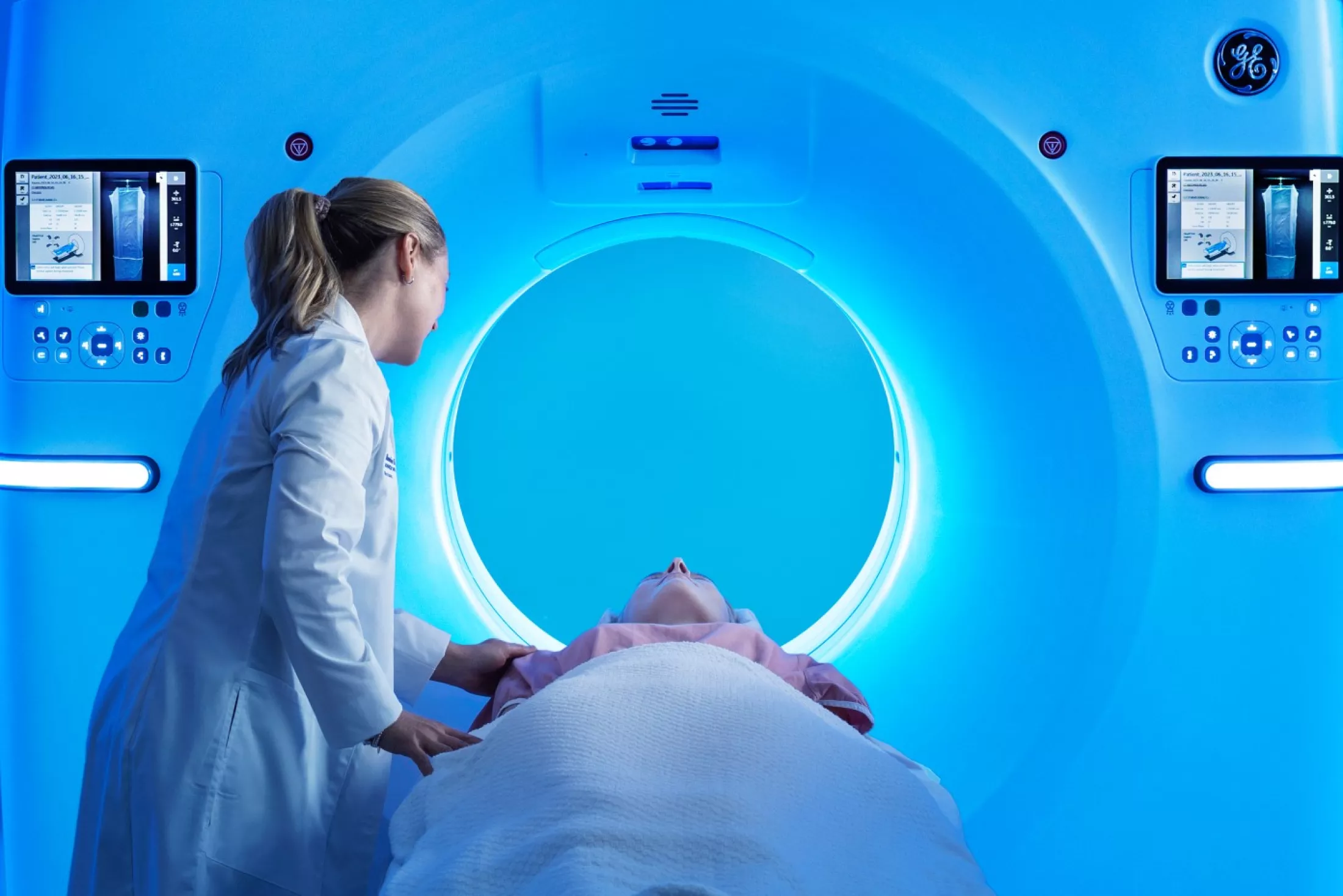 Technician assisting a relaxed patient in modern CT Scan machine