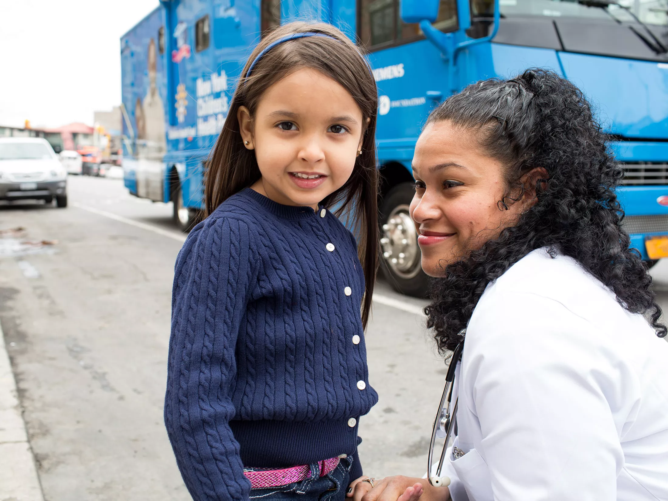 A physician with a young girl at an event