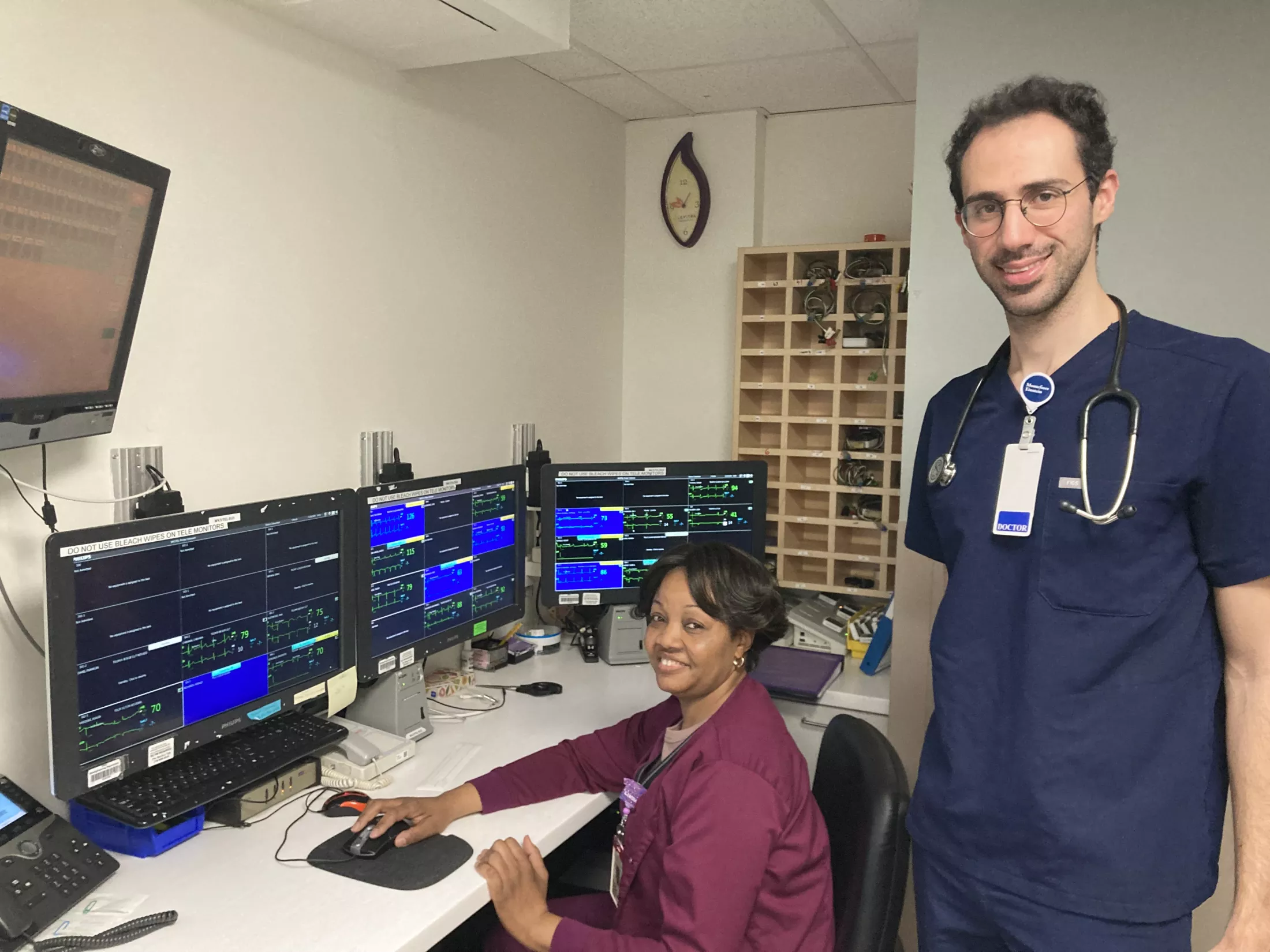 Linda Cesar (seated), telemetry aide, with resident physician Dr. Rafic Nabbout, in the telemetry unit’s monitoring room. 