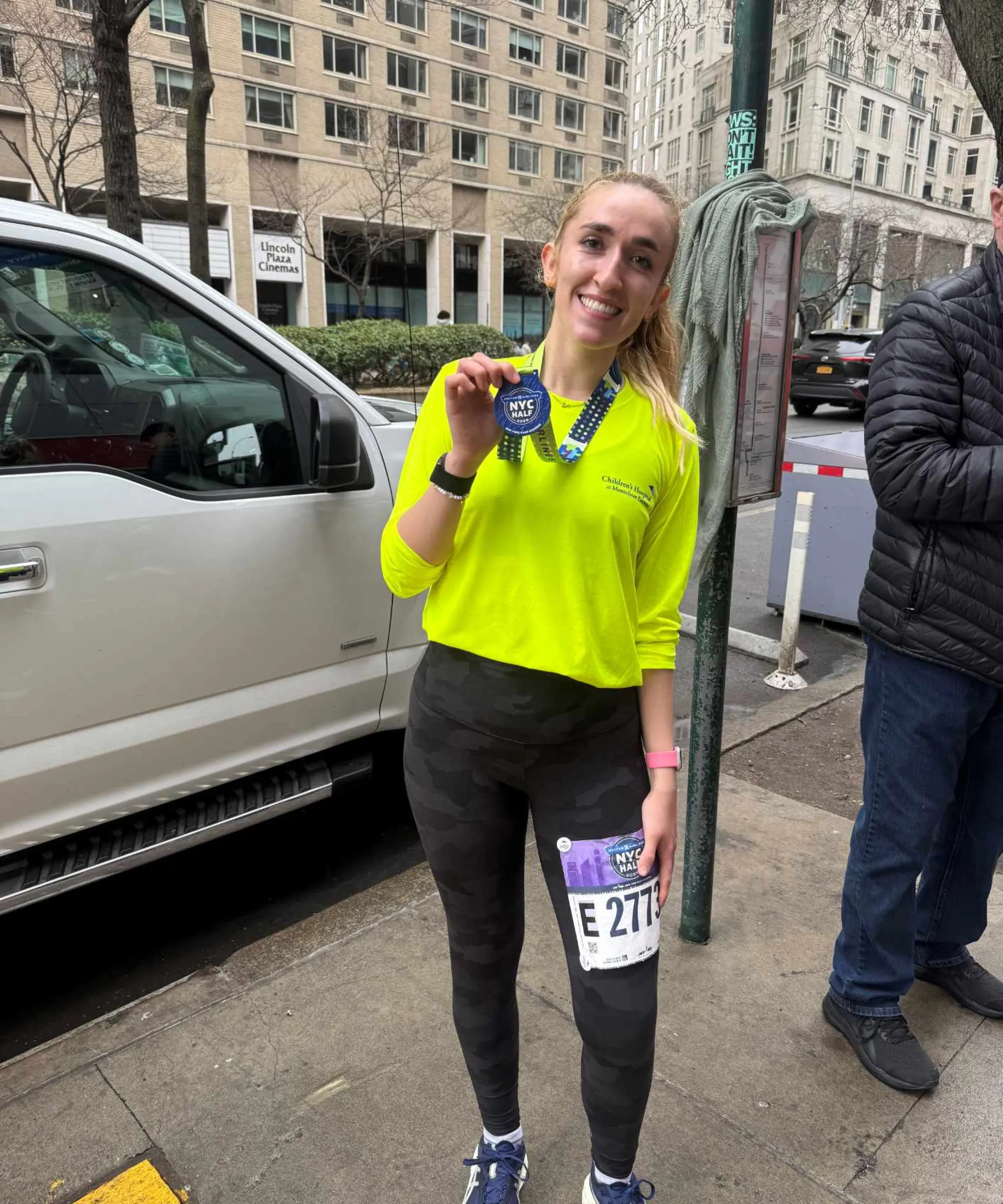 Runner showing medal