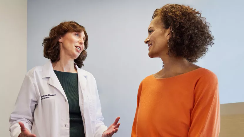 Woman doctor speaking with woman patient