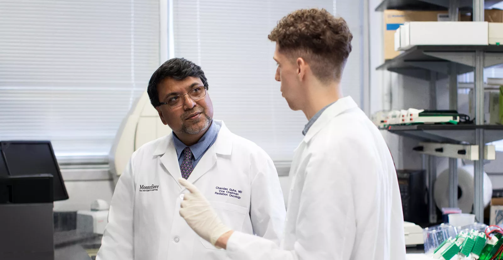 Medical professional instructing student in training. 