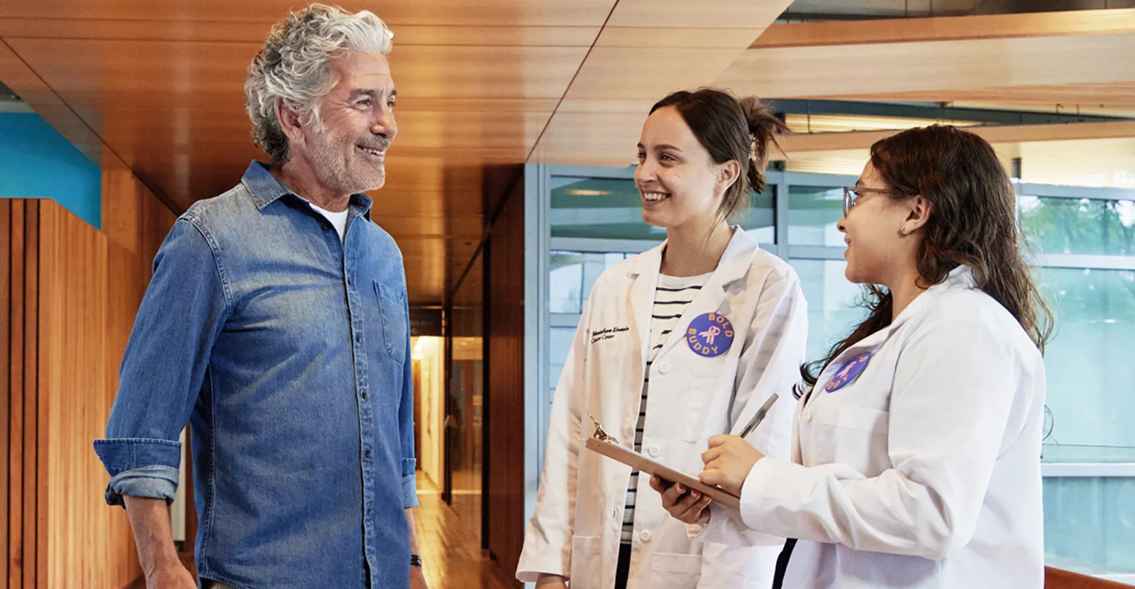 BOLD interns talk with patient.