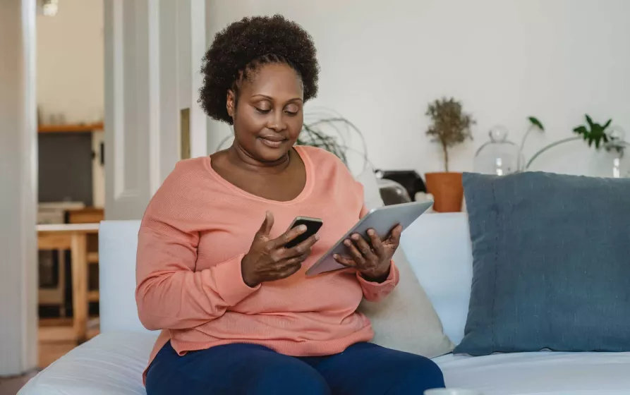 Woman using phone and tablet
