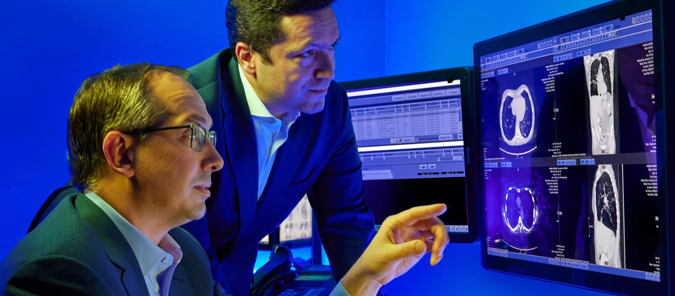 Two physicians looking at a computer screen