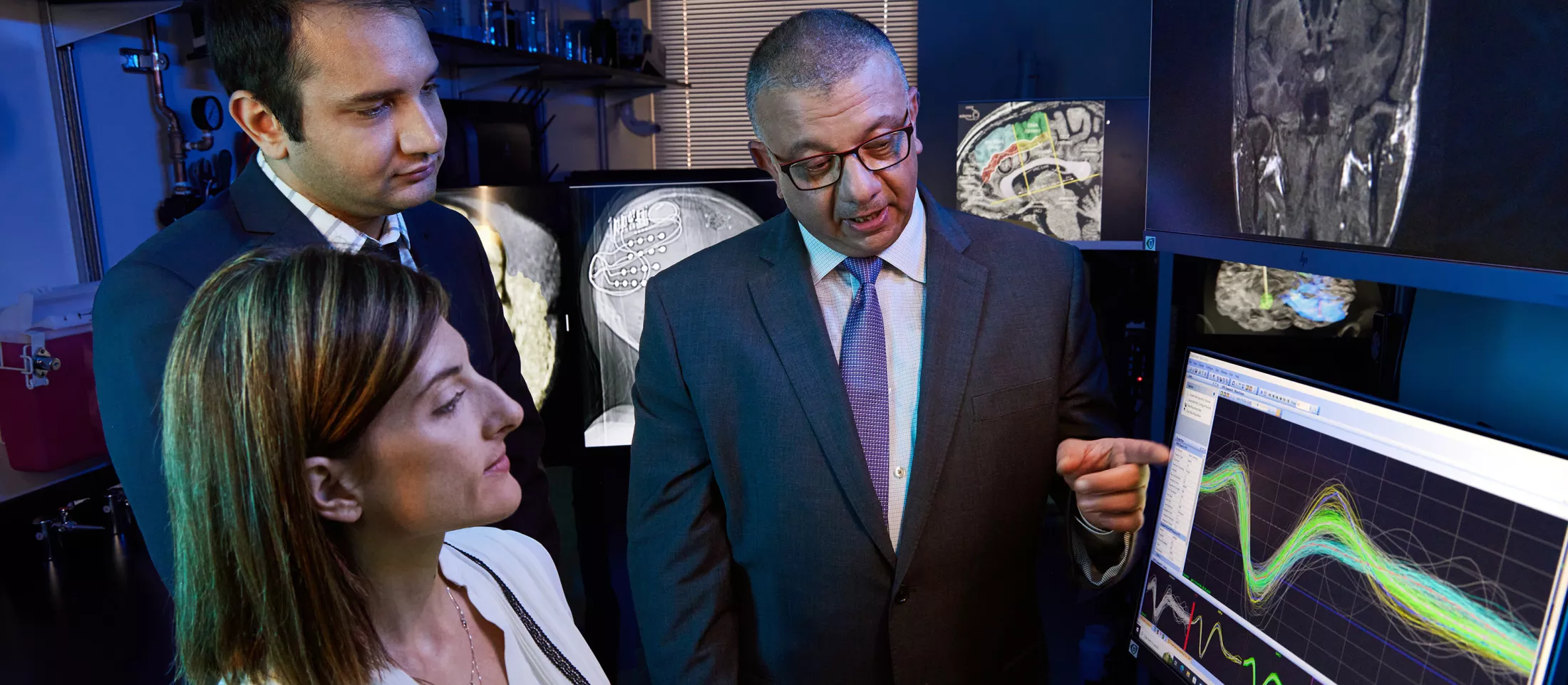 Researchers gathered around computer screens having a discussion