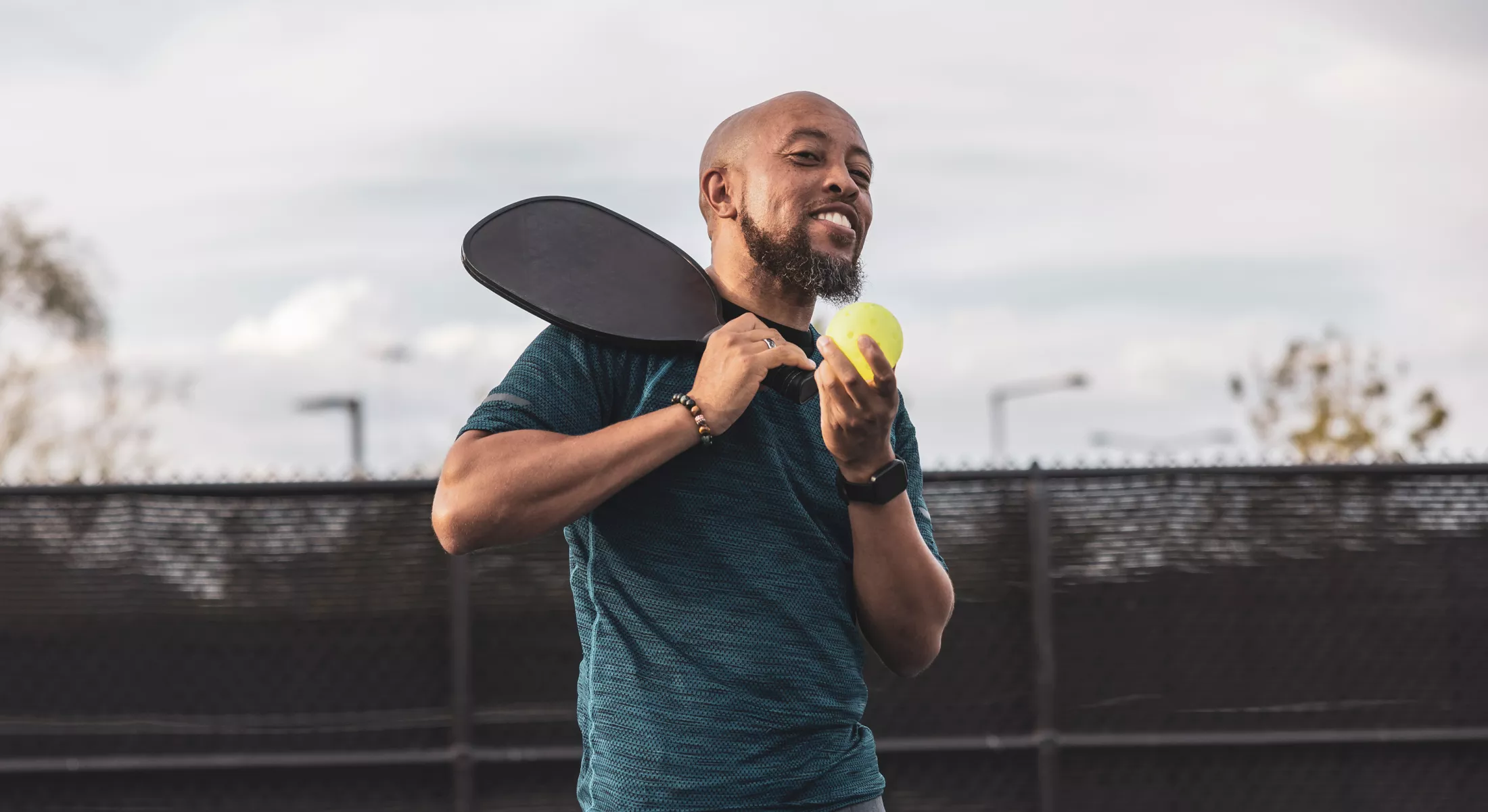 African American man playing pickleball.