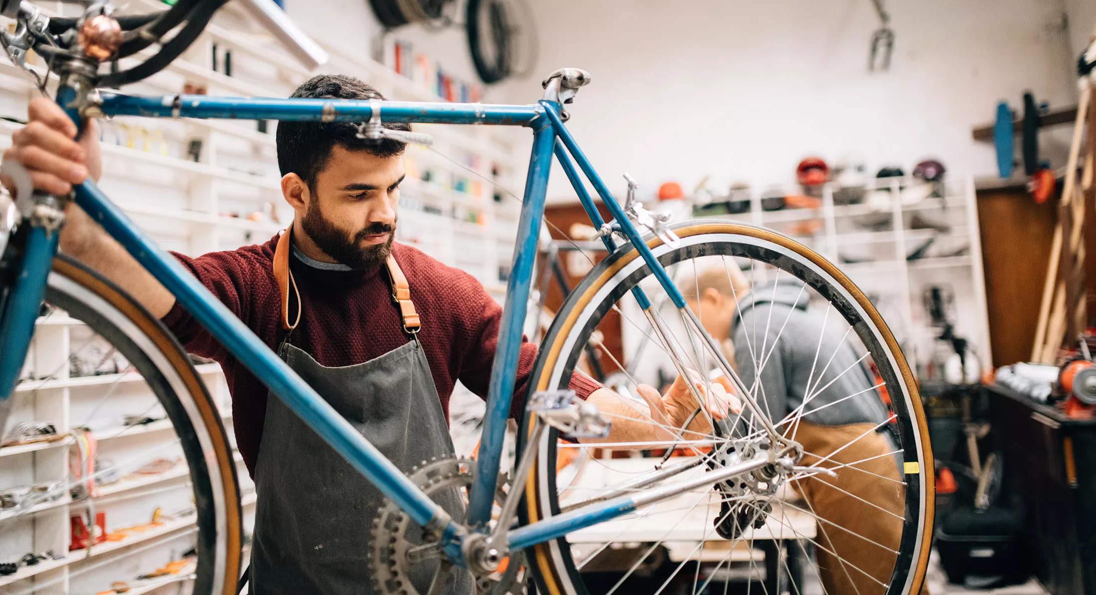 Bike shop owner working on vintage bicycle