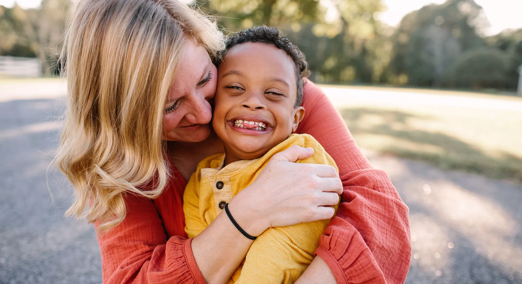 A mother hugging her son with Down Syndrome