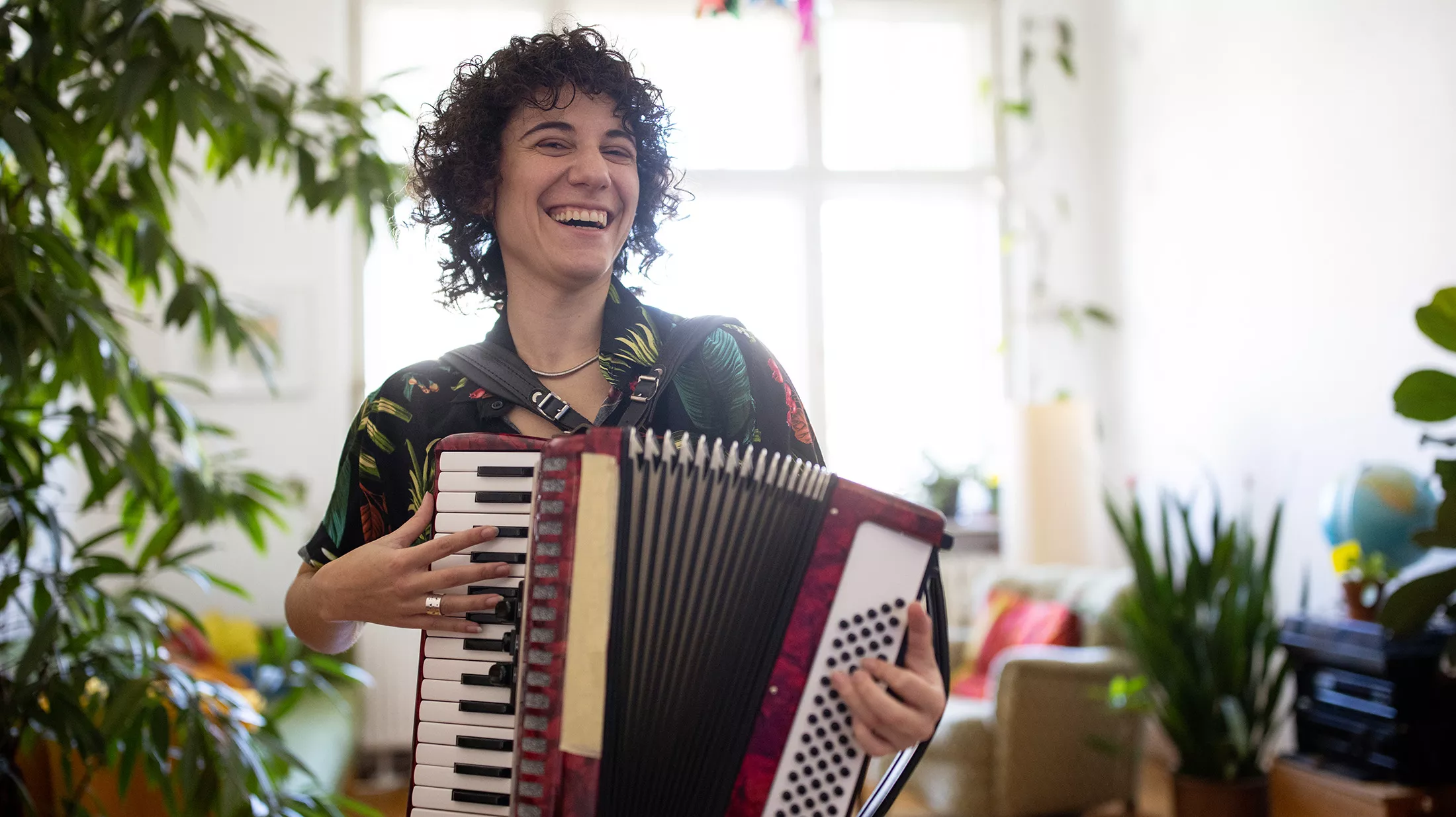 Happy person playing vintage accordion. 