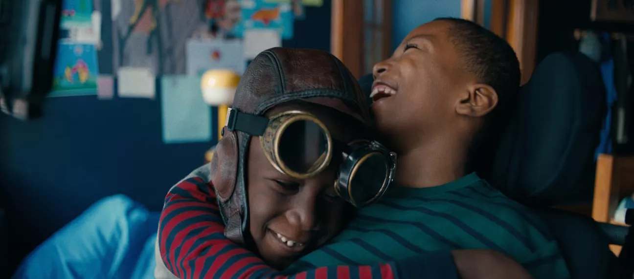 Two brothers laughing and hugging