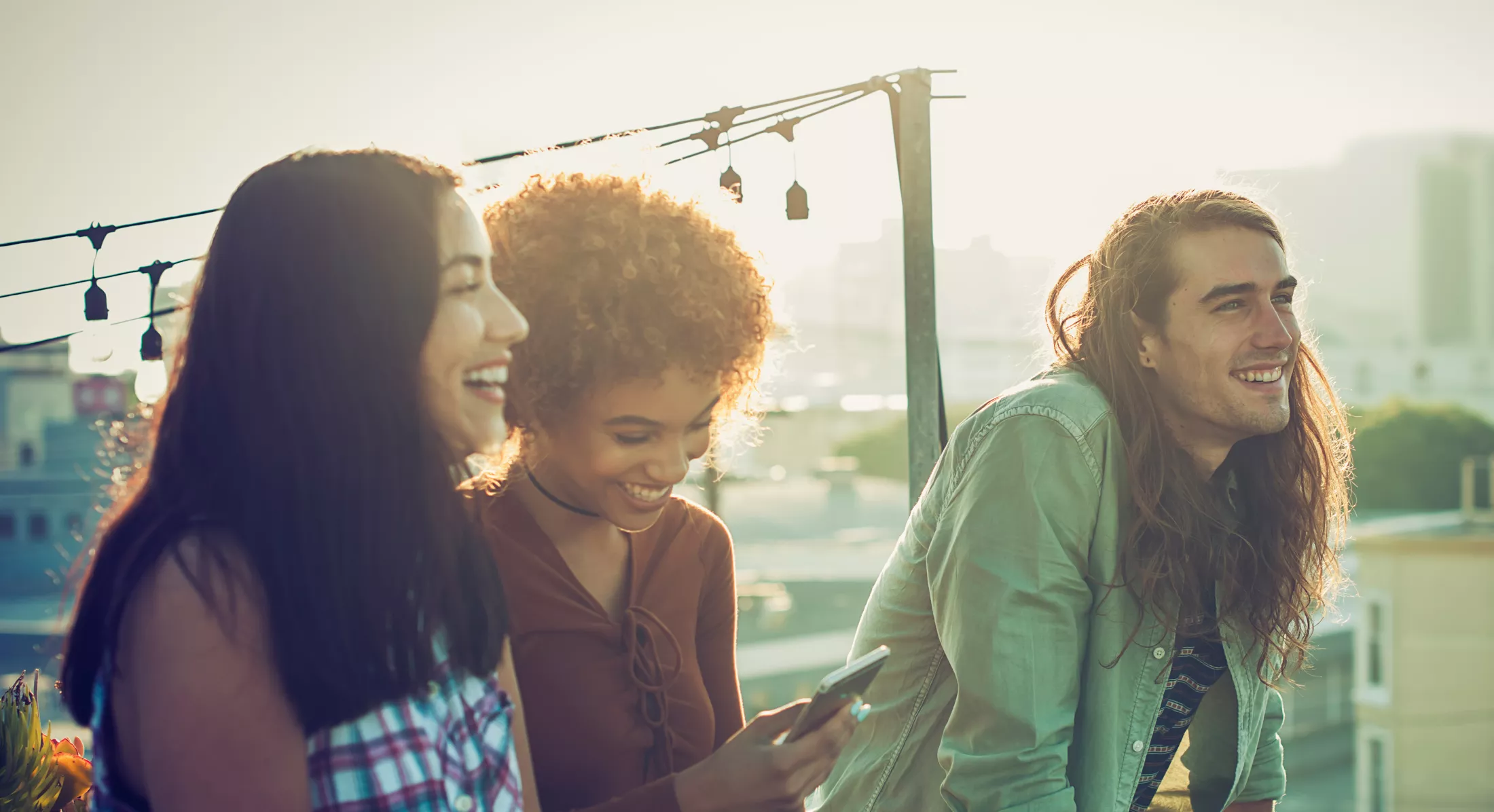 Friends sharing a laugh on urban rooftop