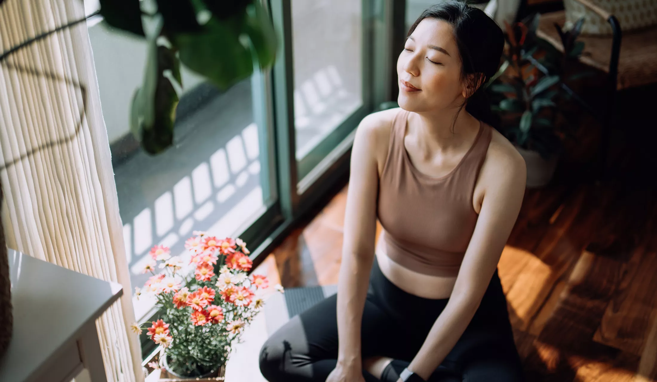 A young woman meditating in her home