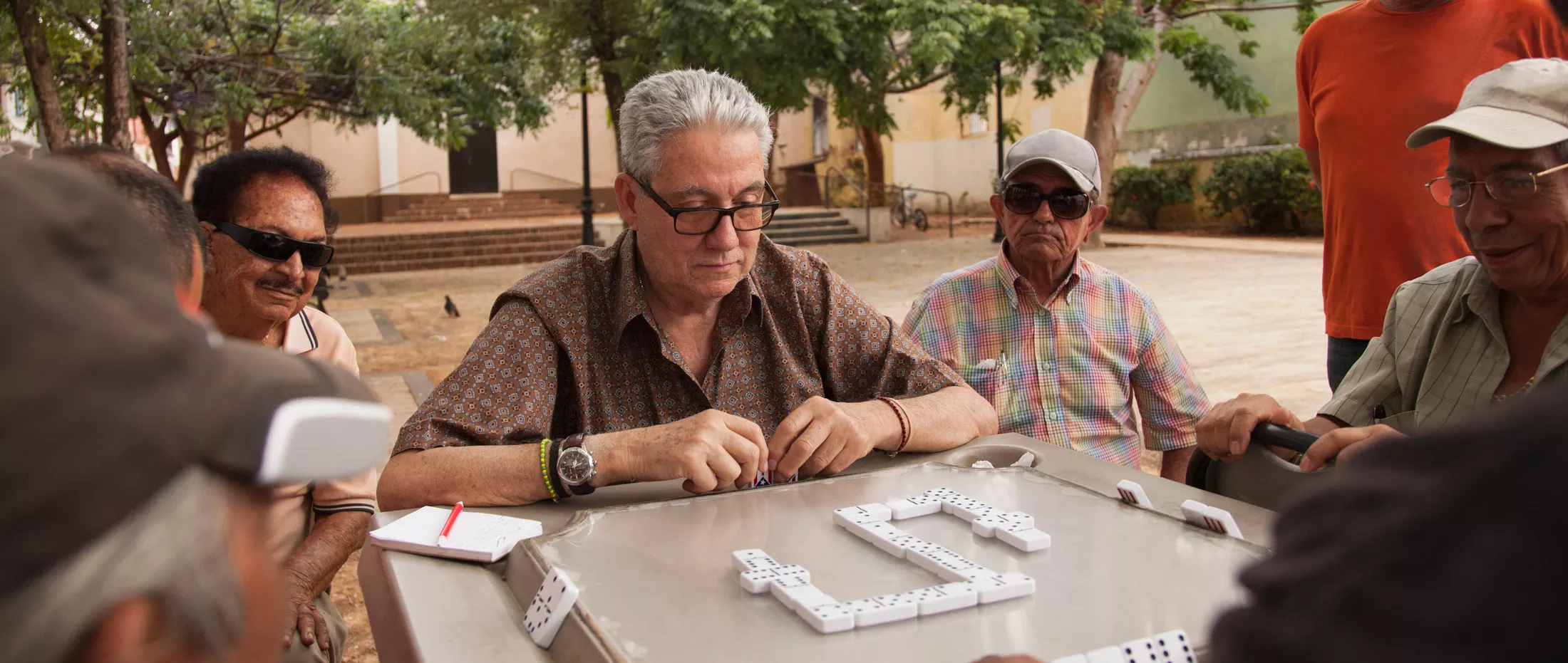 A group of men enjoying a game of dominos.