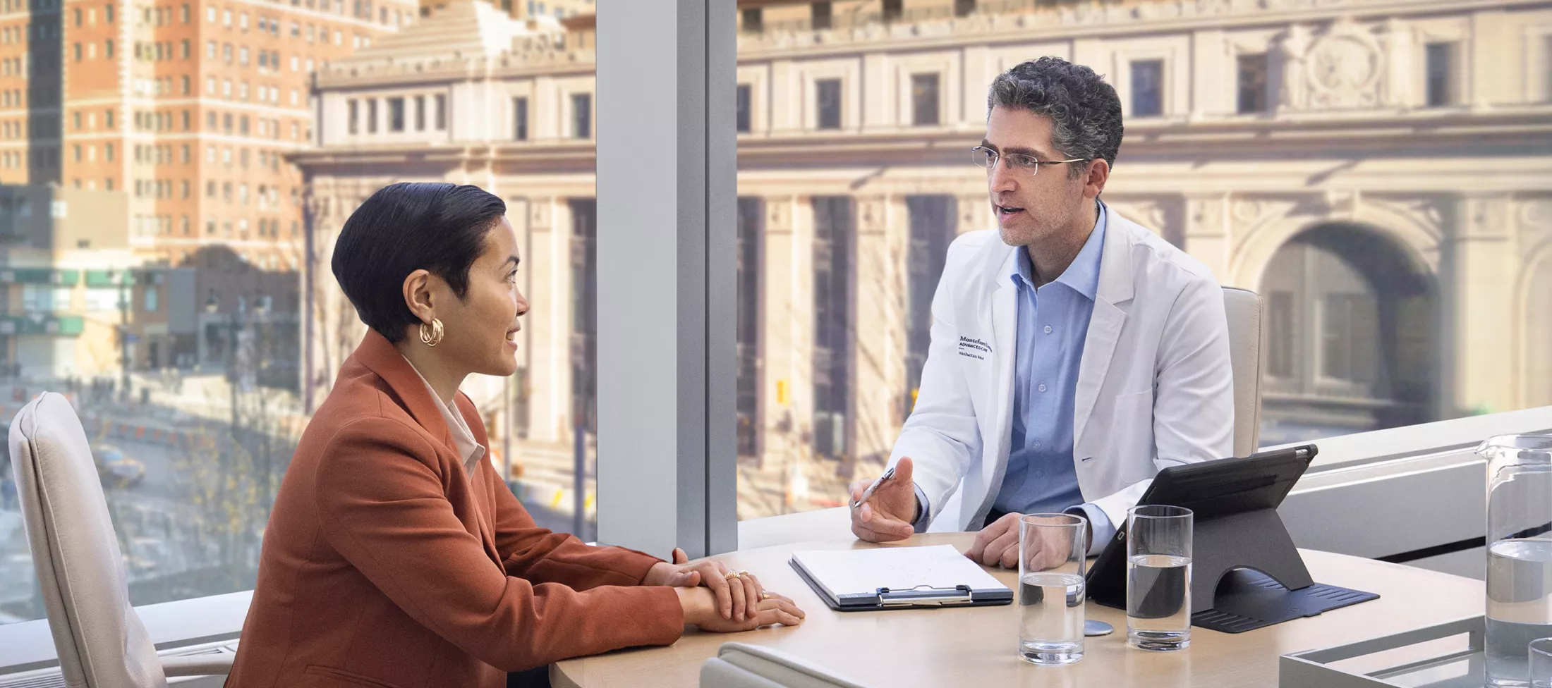 A doctor talking to a patient in a hospital room