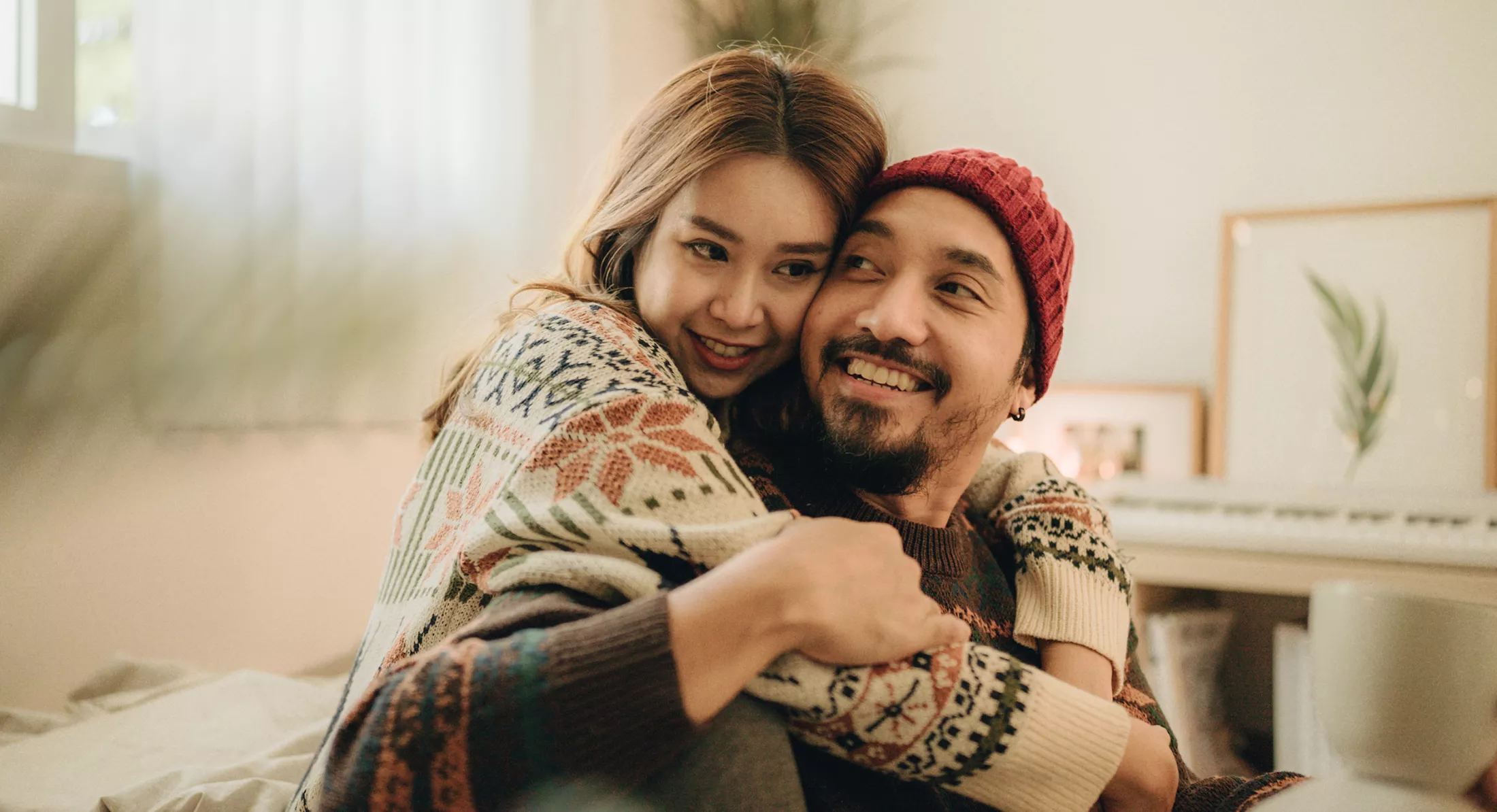 Happy young couple relaxing talking laughing drinking coffee tea 