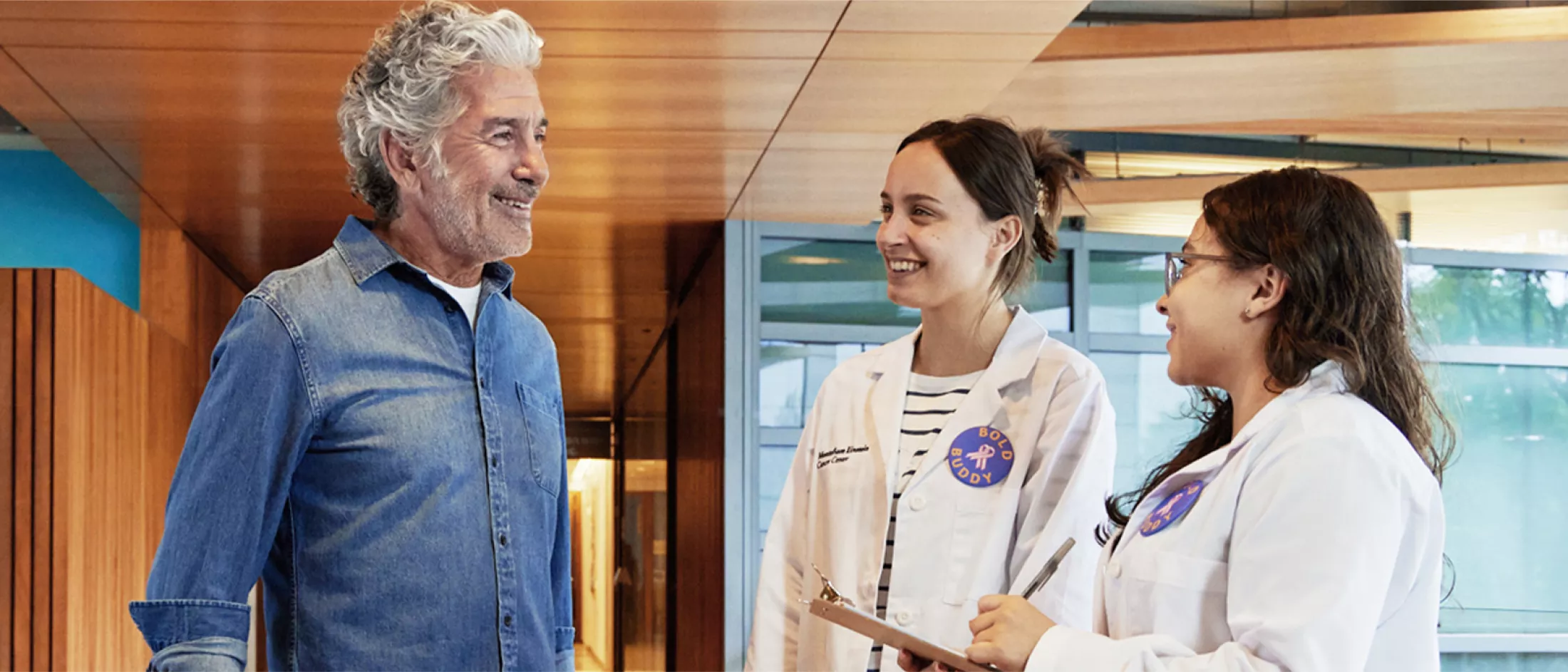 A patient talking with two physicians in a hospital