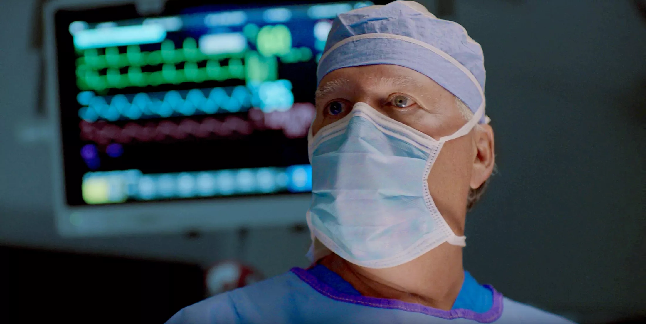 A surgeon looking at a monitor in the operating room