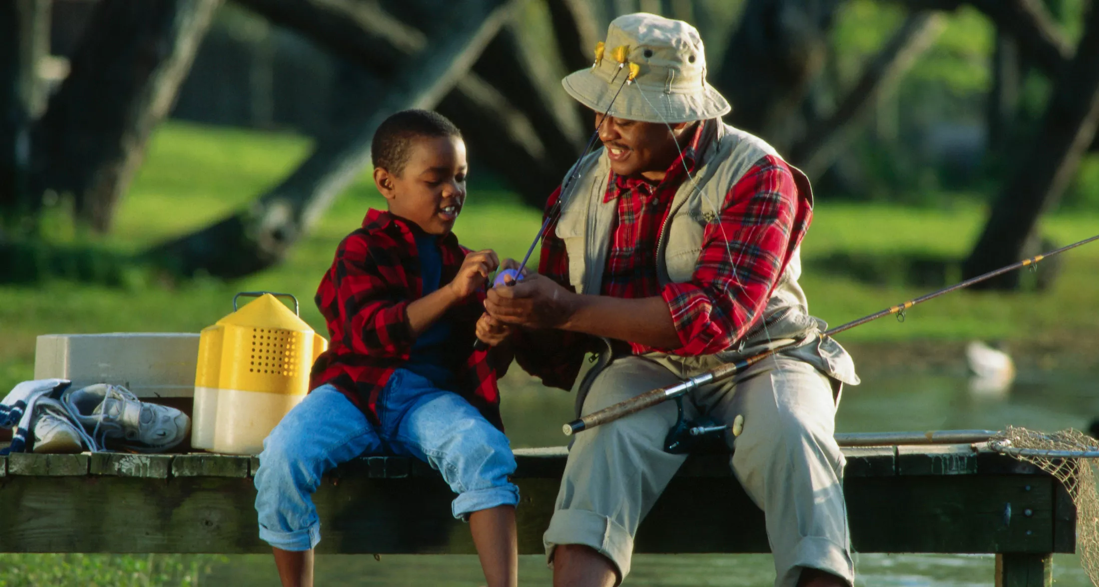 Father and son fishing on a dock