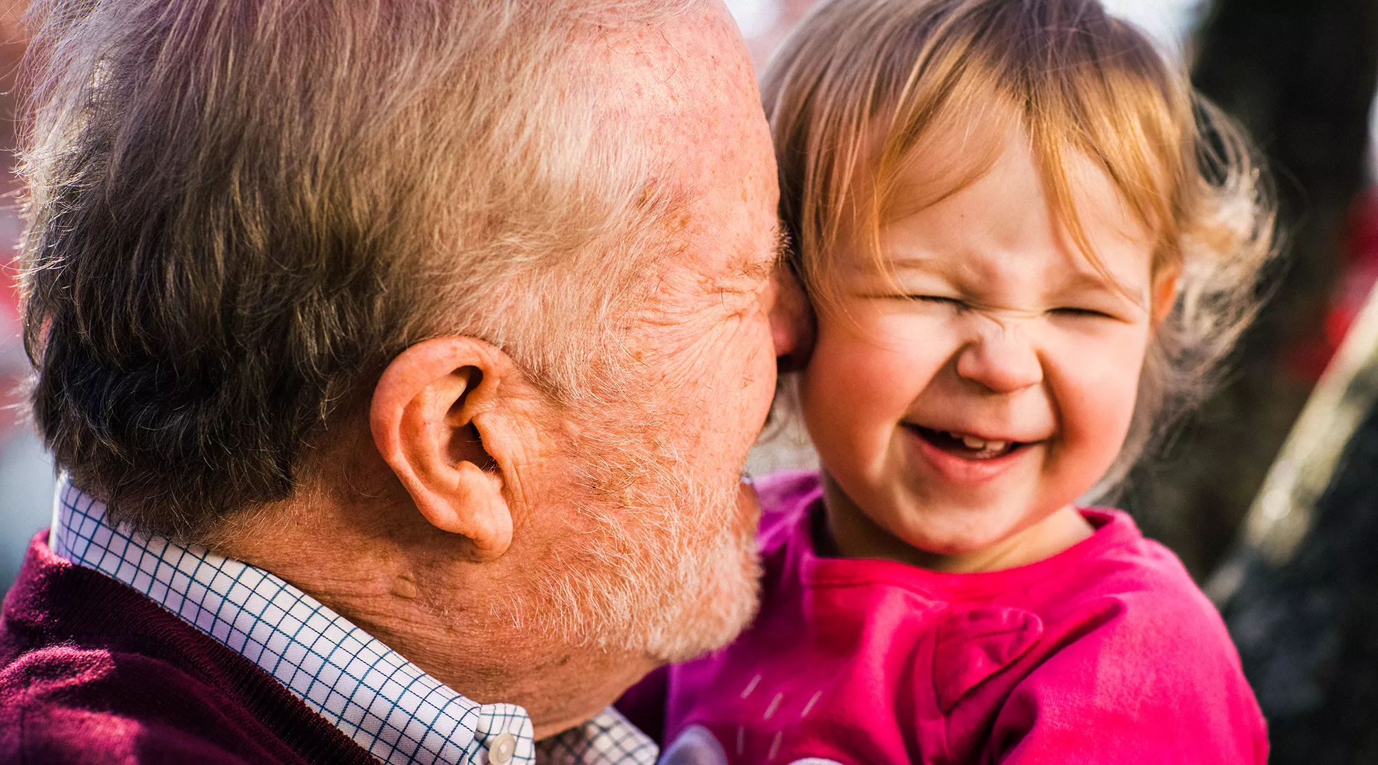 James holding his granddaughter in the park