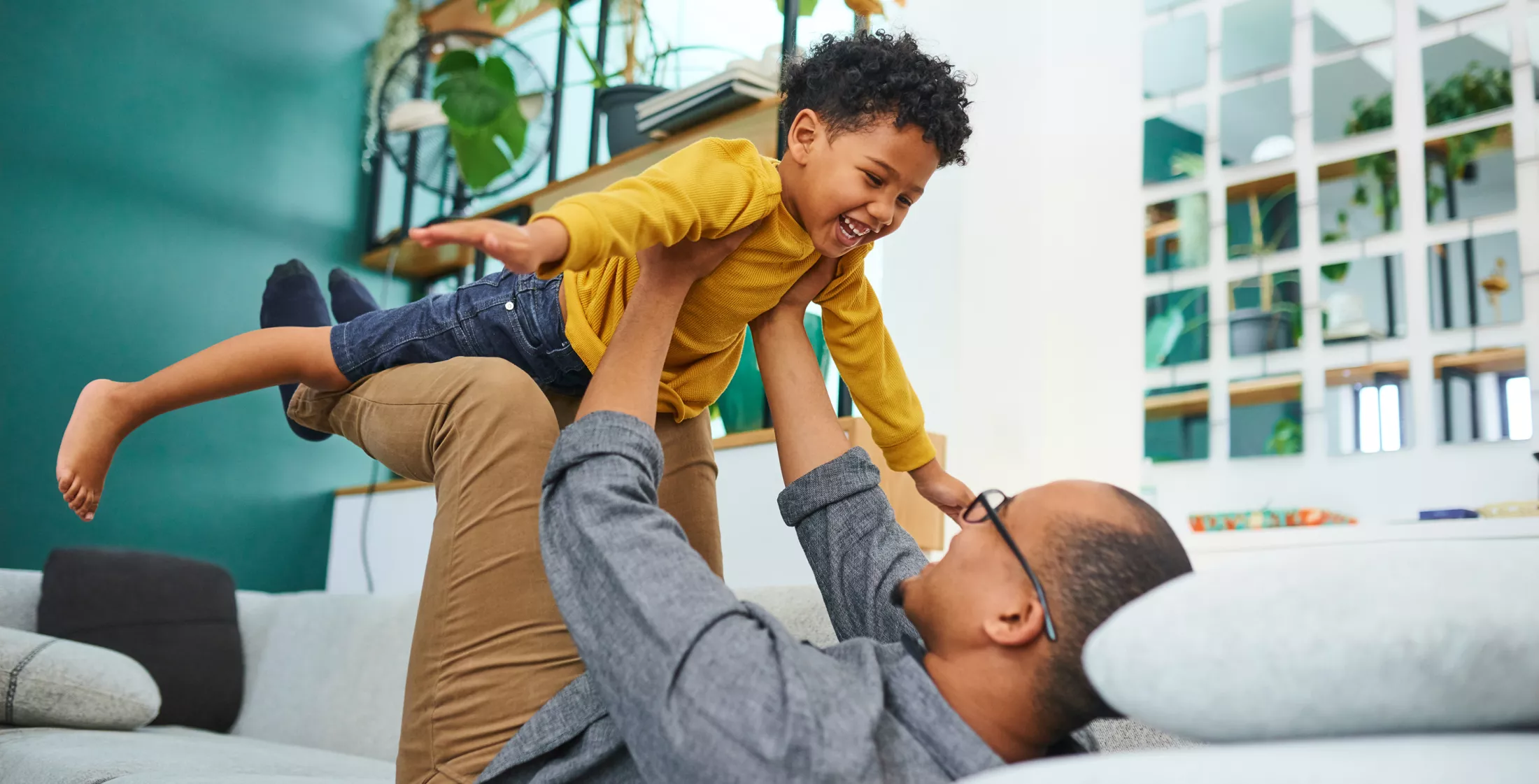Father and son playing on the couch
