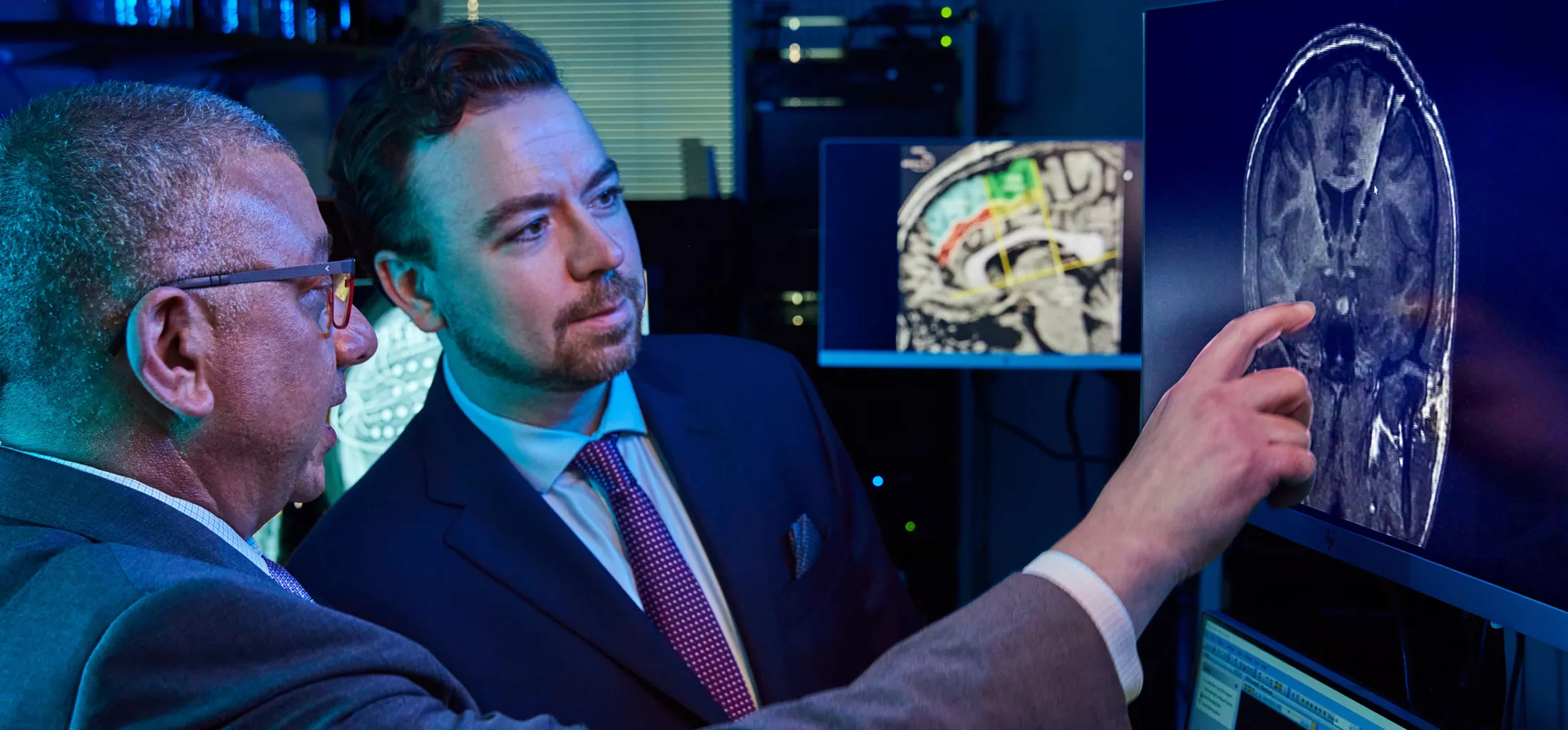 Neurologists in lab reviewing brain images