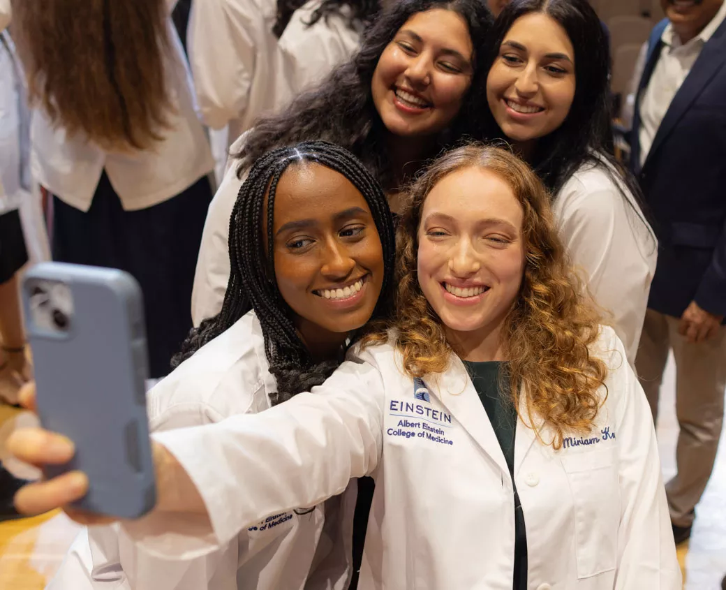 Members of the Class of 2028 celebrate after receiving their white coats. 