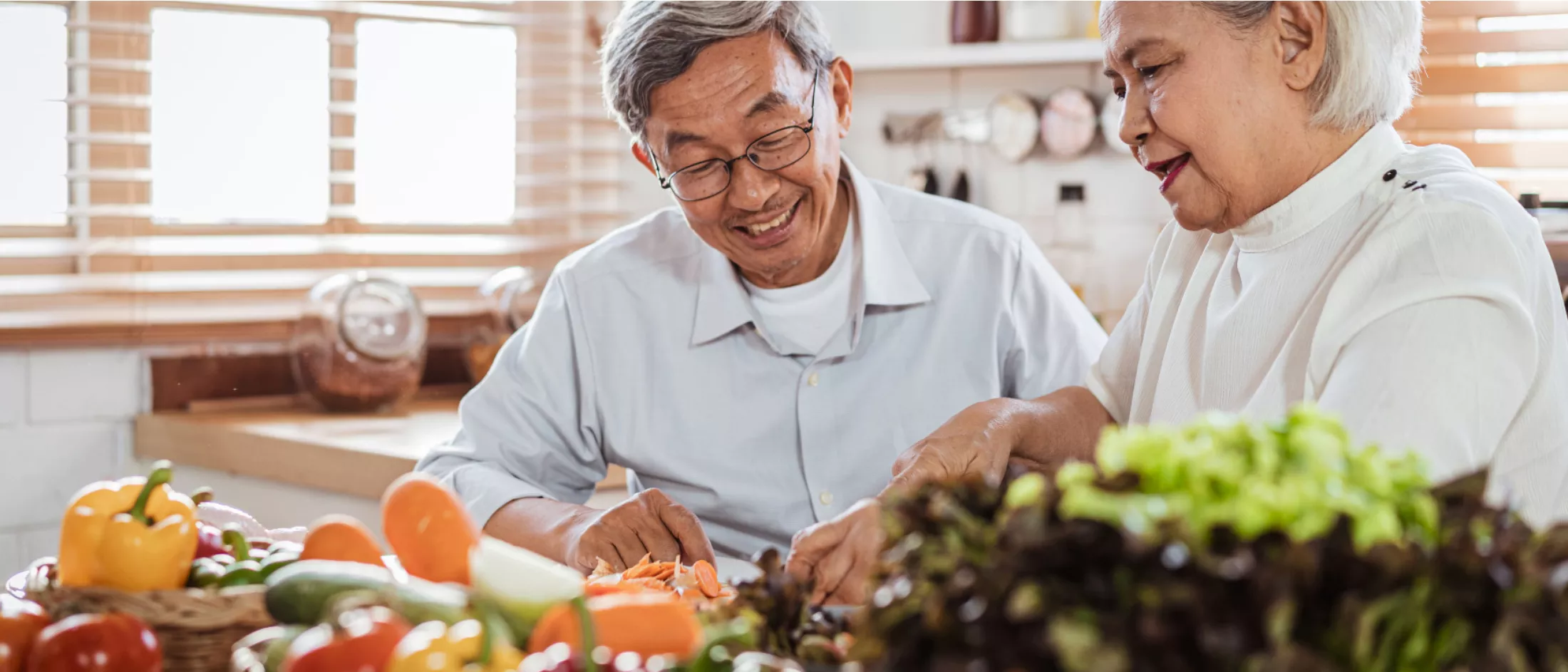 Senior Man and Woman cooking healthy food together