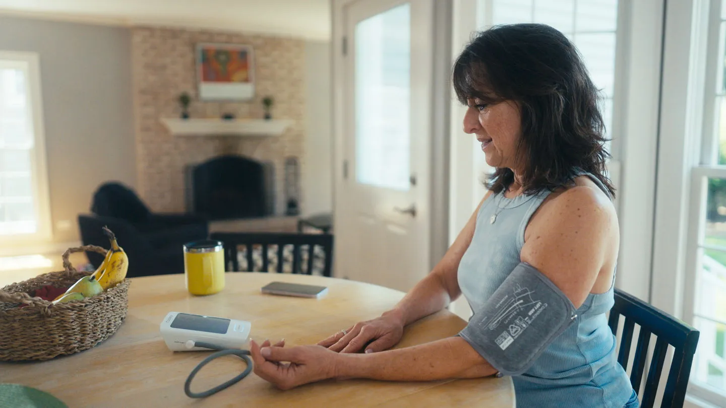 A woman taking her blood pressure